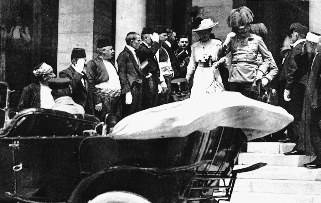 The reception in the Town Hall over, and with Franz Ferdinand having decided that he wants to visit his wounded adjutant in the hospital, the royal couple emerges from the building.